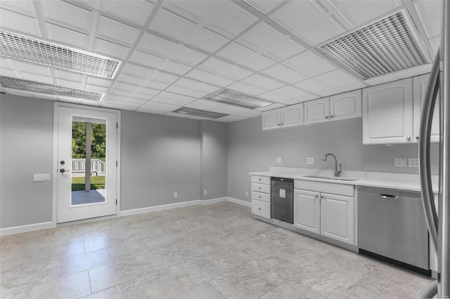 kitchen with stainless steel appliances, sink, and white cabinetry