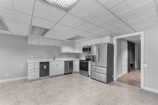 kitchen featuring appliances with stainless steel finishes, light wood-type flooring, sink, and white cabinets