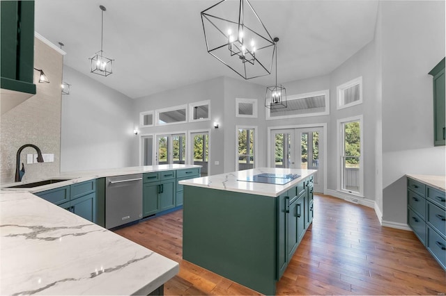 kitchen with pendant lighting, a kitchen island, dark wood-type flooring, sink, and stainless steel dishwasher