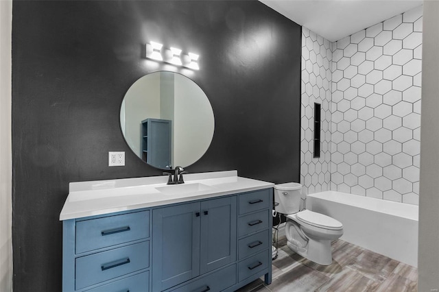 full bathroom with vanity, tiled shower / bath combo, and toilet