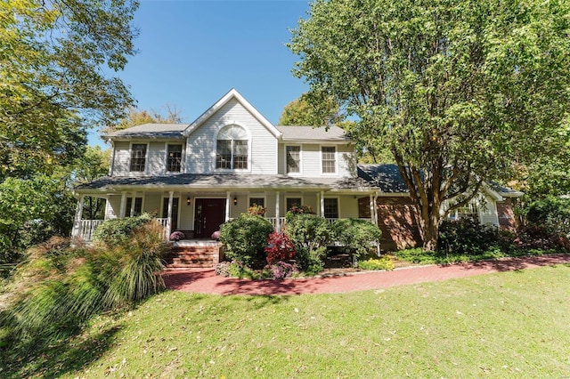 view of front facade with a front yard and covered porch