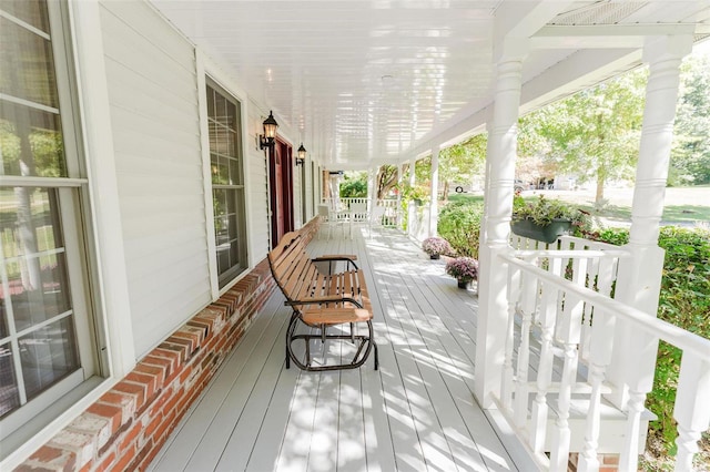 wooden terrace featuring covered porch