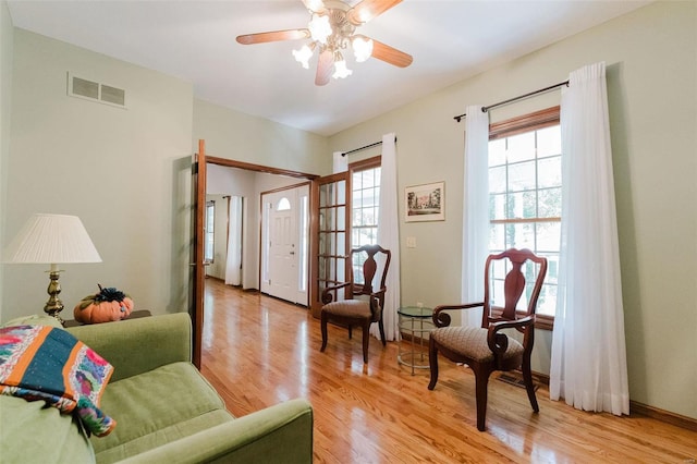 living area featuring ceiling fan and light wood-type flooring