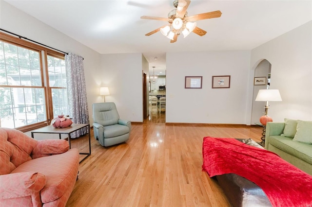 living room featuring ceiling fan and light hardwood / wood-style floors