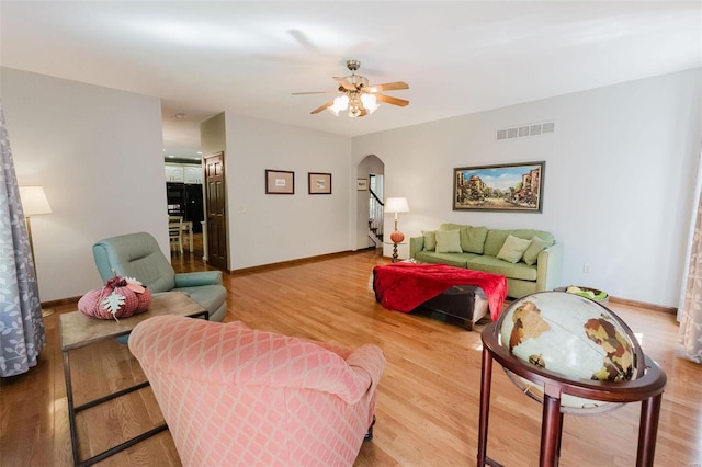 living room featuring hardwood / wood-style flooring and ceiling fan