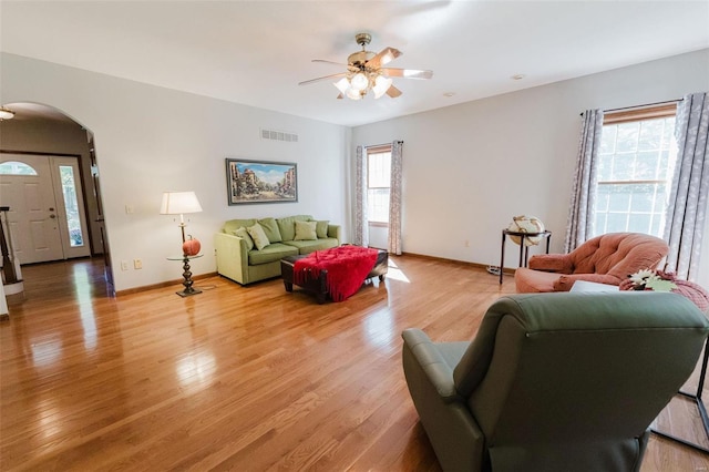 living room with light hardwood / wood-style flooring, a wealth of natural light, and ceiling fan