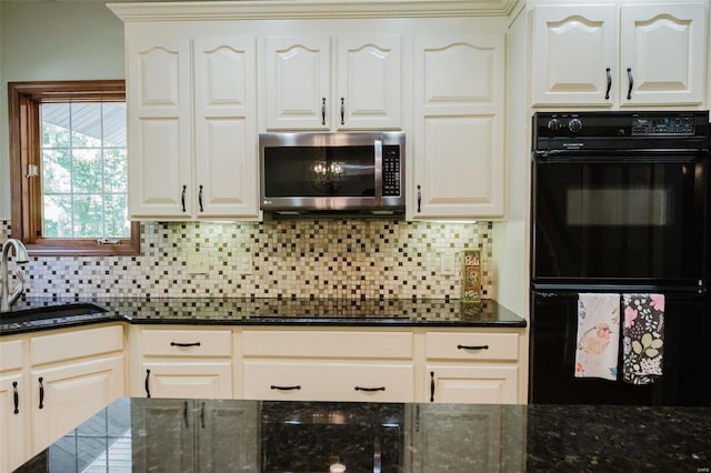 kitchen with white cabinets, black appliances, and sink