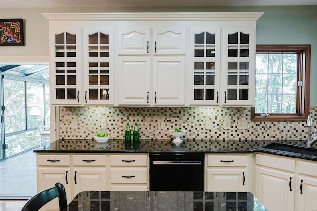 kitchen with dark stone counters, white cabinetry, and dishwasher