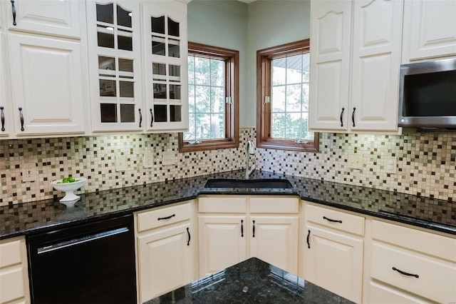 kitchen with dishwasher, decorative backsplash, sink, and white cabinetry