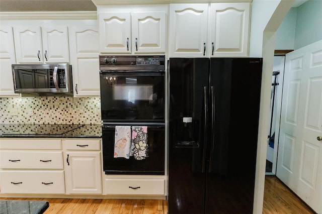 kitchen featuring black appliances, decorative backsplash, light hardwood / wood-style floors, and white cabinets