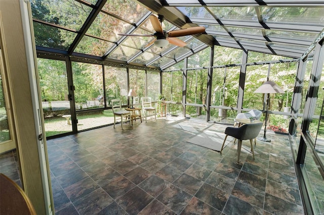 unfurnished sunroom featuring lofted ceiling and ceiling fan