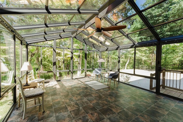 unfurnished sunroom featuring vaulted ceiling and ceiling fan