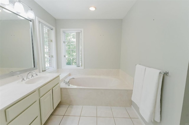 bathroom featuring vanity, a bath, and tile patterned floors