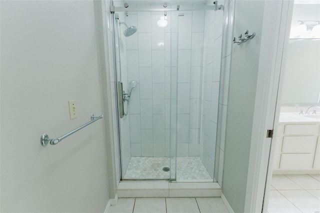 bathroom with tile patterned floors, vanity, and an enclosed shower