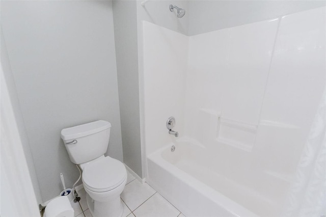 bathroom featuring tile patterned flooring, shower / tub combo with curtain, and toilet