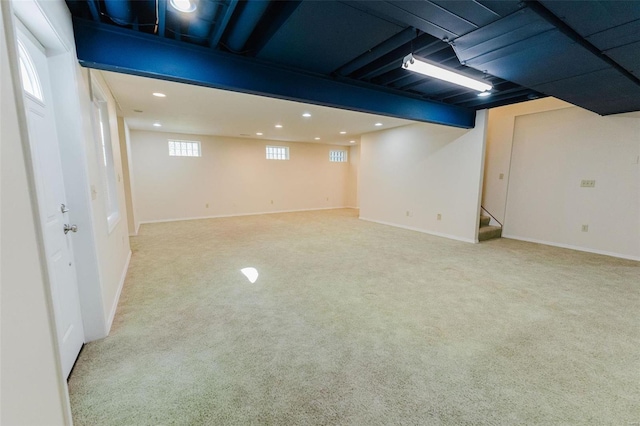 basement featuring light carpet