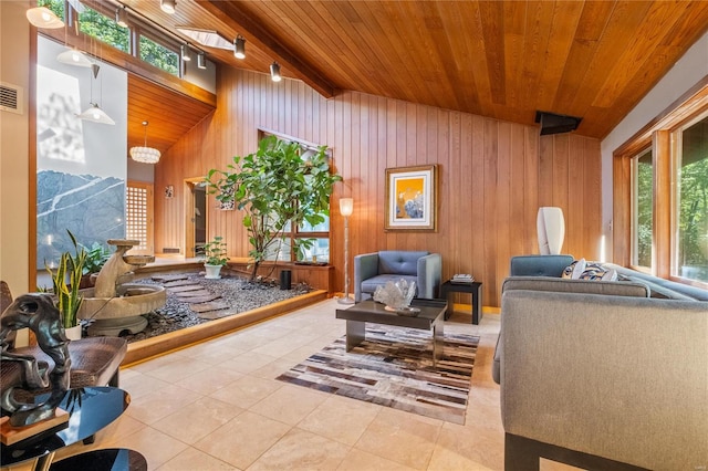 interior space with vaulted ceiling with beams, wooden walls, a healthy amount of sunlight, and wooden ceiling