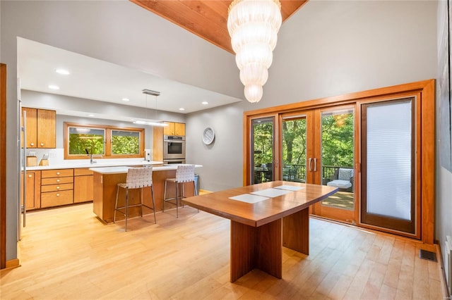 dining room featuring a notable chandelier, light wood-type flooring, and sink