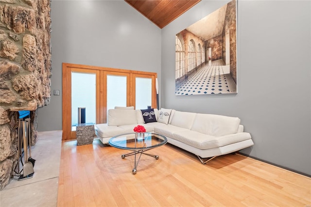 living room with hardwood / wood-style flooring, high vaulted ceiling, and wooden ceiling