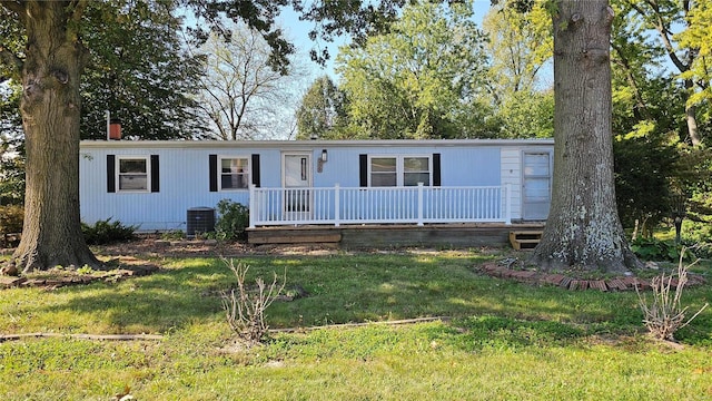 view of front of house with a front lawn and central air condition unit