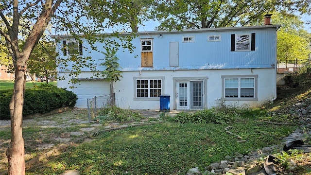 rear view of house with a garage