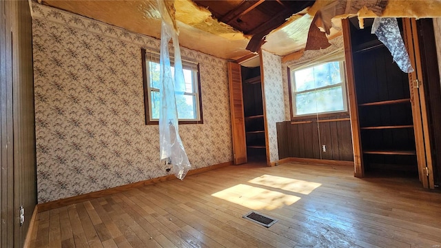 spare room with hardwood / wood-style floors and a wealth of natural light