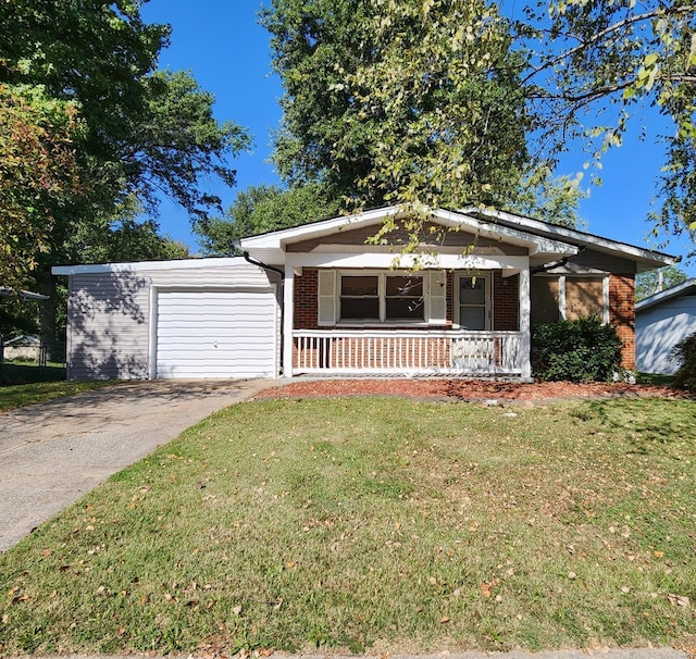 view of front of house featuring a garage, a front yard, and covered porch