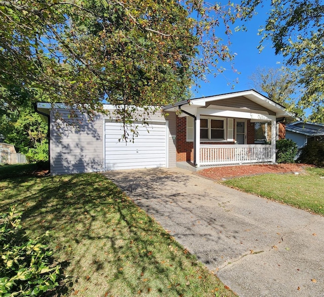 ranch-style home featuring a garage, a front yard, and covered porch