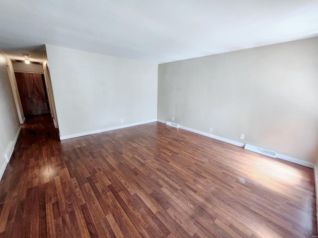 spare room with dark hardwood / wood-style floors