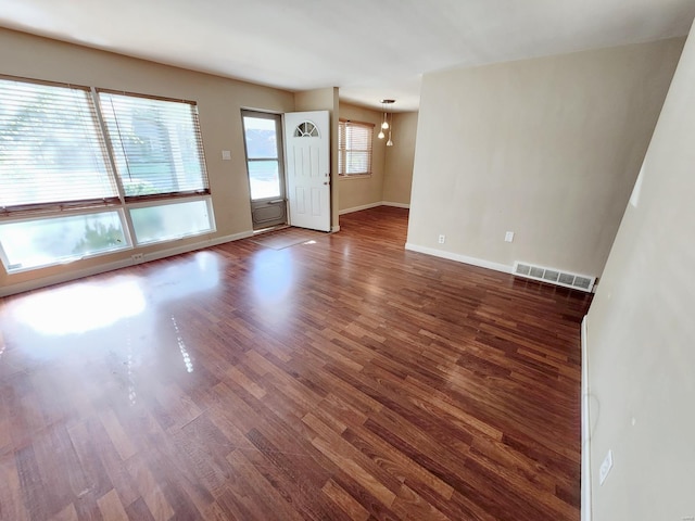 unfurnished living room with dark hardwood / wood-style flooring