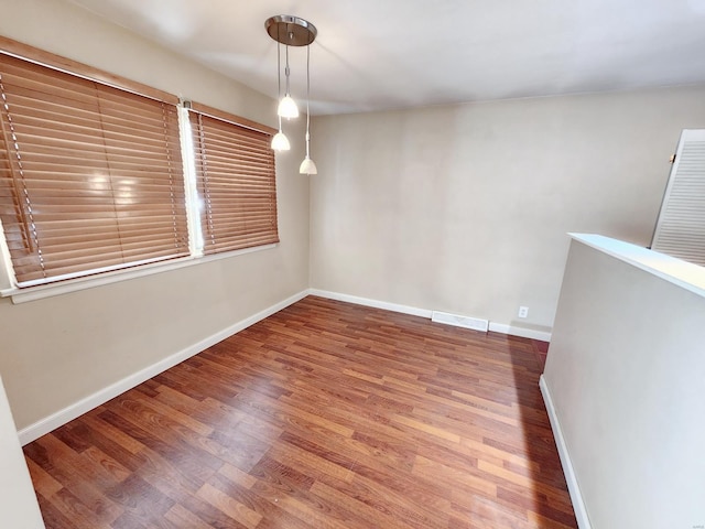 unfurnished room featuring hardwood / wood-style flooring