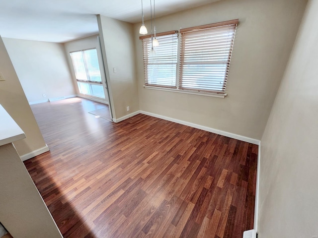 unfurnished dining area featuring dark wood-type flooring