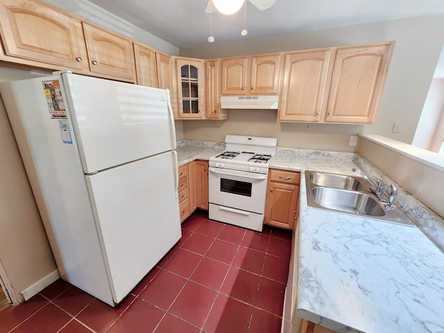 kitchen featuring ceiling fan, light brown cabinets, dark tile patterned flooring, sink, and white appliances