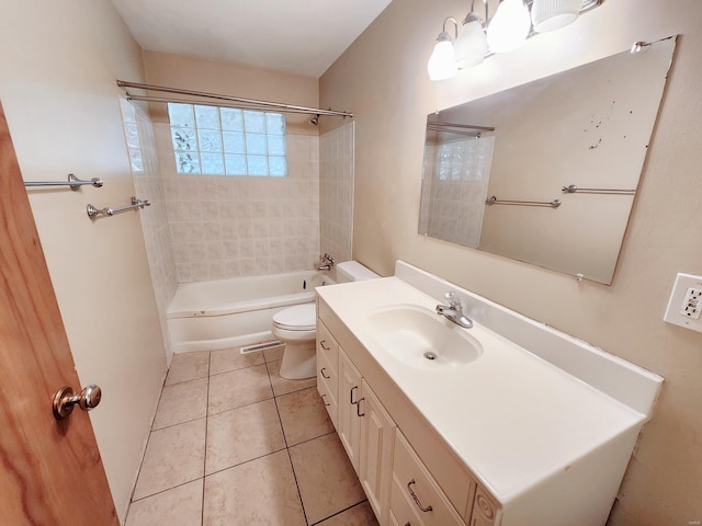 full bathroom with tile patterned flooring, vanity, toilet, and tiled shower / bath