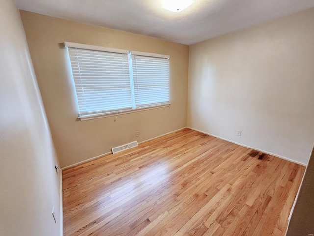 unfurnished room with light wood-type flooring