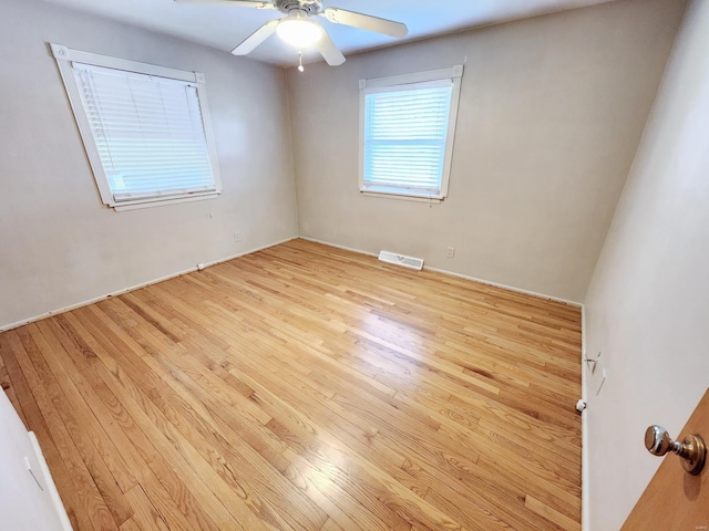 spare room featuring ceiling fan and light wood-type flooring