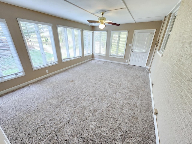 unfurnished sunroom with a healthy amount of sunlight and ceiling fan