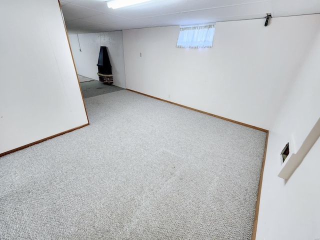 basement featuring carpet flooring and a drop ceiling