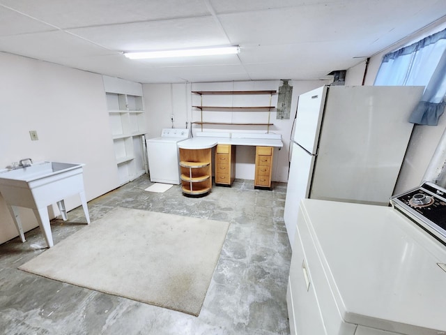 kitchen with washer / dryer and white fridge