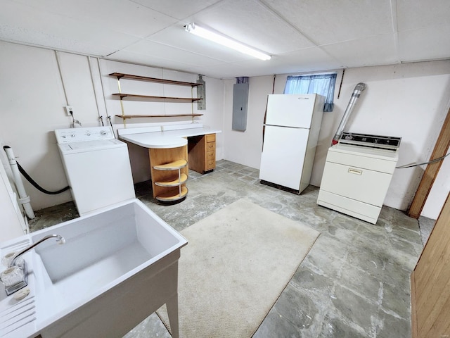 kitchen featuring electric panel, sink, white fridge, a drop ceiling, and separate washer and dryer