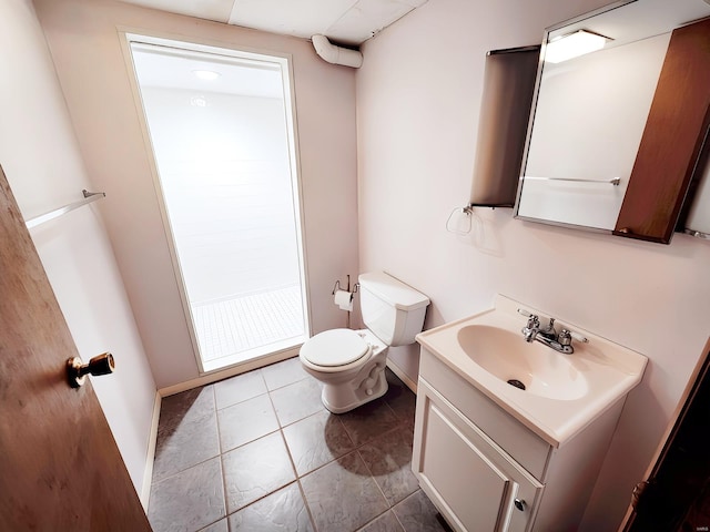 bathroom with vanity, tile patterned flooring, and toilet