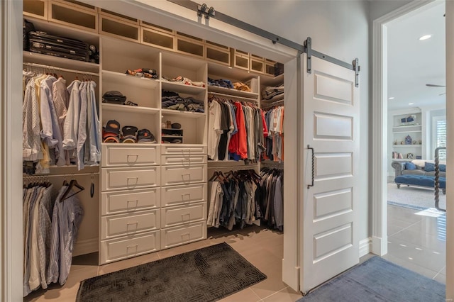 spacious closet with light tile patterned floors