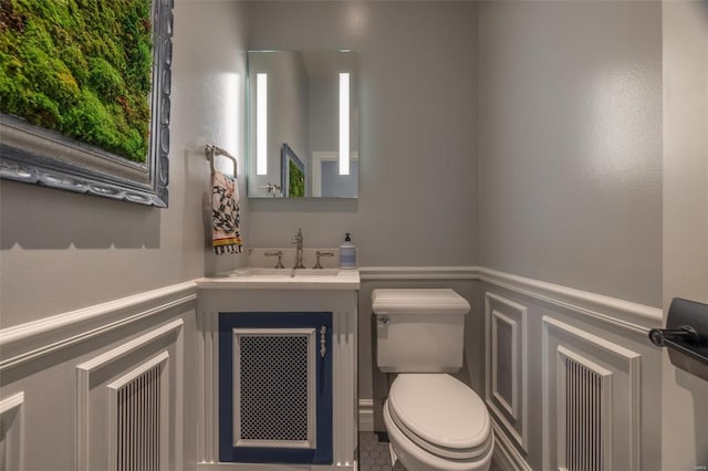 bathroom with vanity, tile patterned floors, and toilet