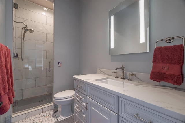 bathroom with tile patterned flooring, a shower with door, vanity, and toilet