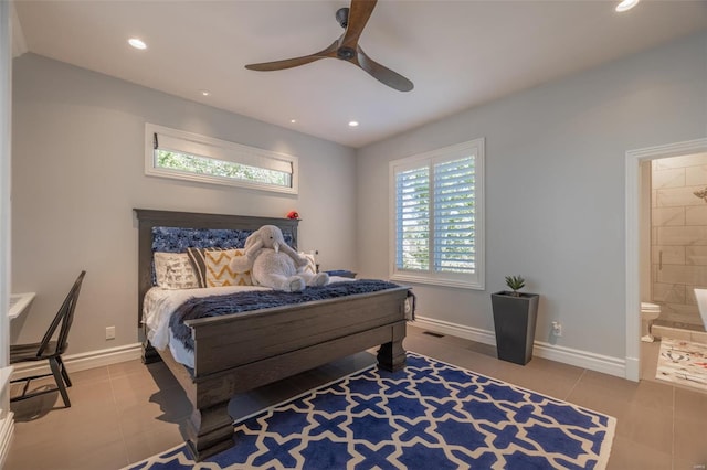 tiled bedroom with ceiling fan and ensuite bath