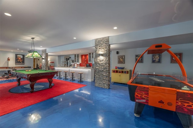 recreation room with concrete floors, decorative columns, and billiards