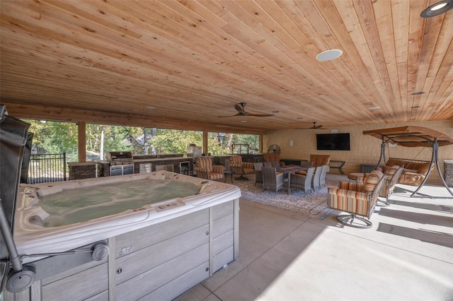 view of patio / terrace featuring ceiling fan and a hot tub