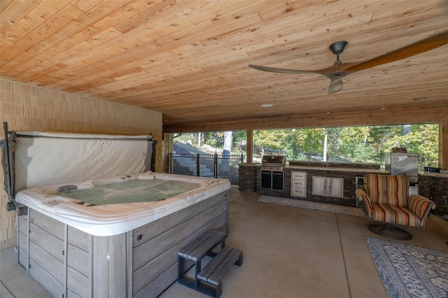 view of patio featuring grilling area, area for grilling, a hot tub, and ceiling fan