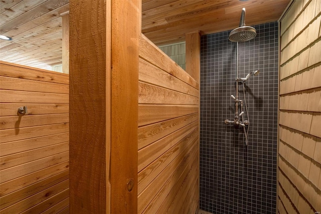 bathroom featuring a tile shower and wood ceiling