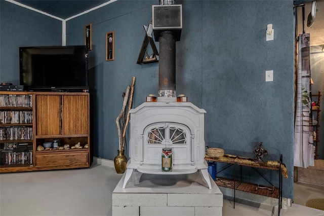 details featuring a wood stove and concrete flooring